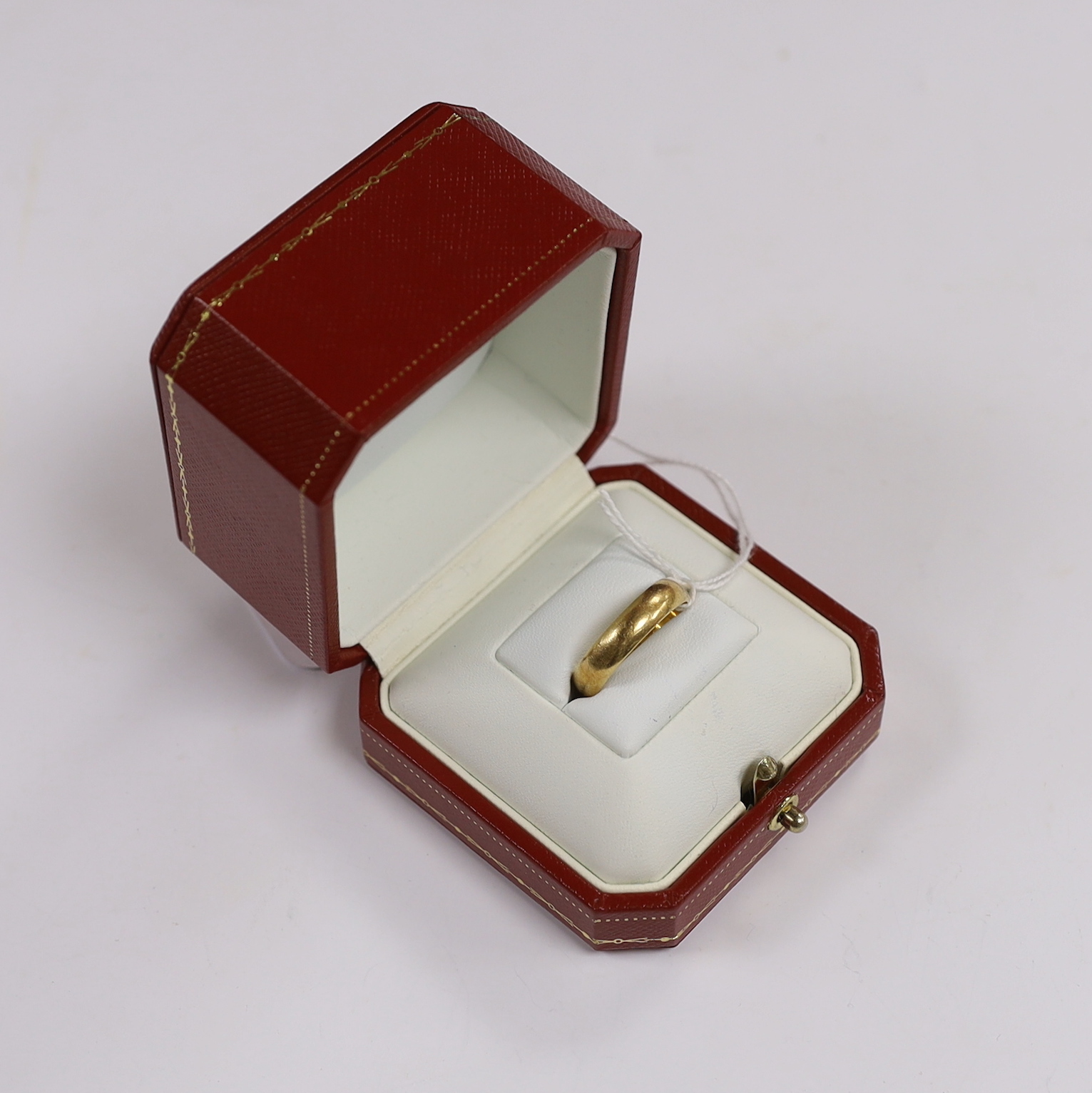 A modern Cartier 750 yellow metal wedding band, signed and numbered 62 JA 0005, with engraved inscription 'Lobster's Love', size U, 5 grams, with Cartier boxes.